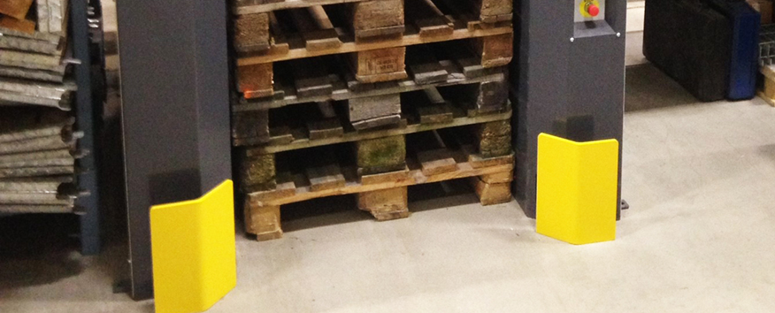 Yellow forklift protection barrier set in front of the PalletMaster® dispenser to protect it from contact