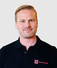 Close-up of an employee wearing a black t-shirt, smiling at the camera