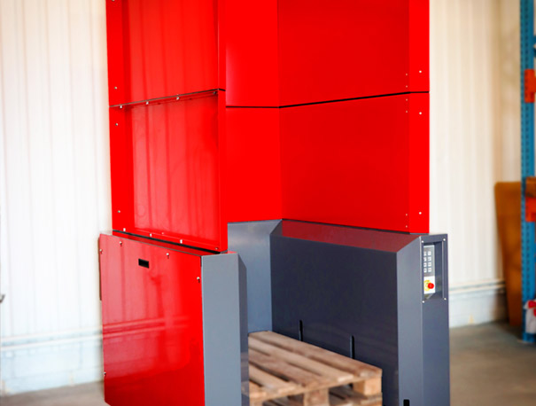 Red M-size PalletMaster® electric pallet dispenser with 2 wooden pallets inside