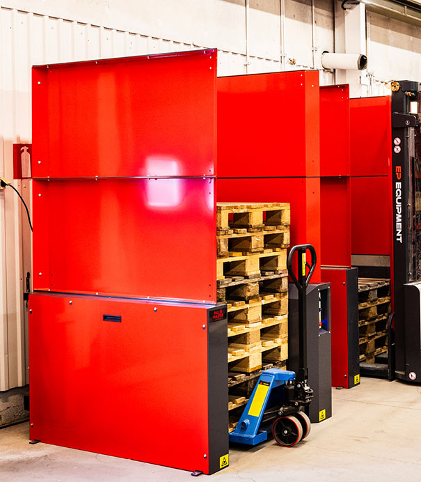 PalletMaster® dispenser with several wooden pallets inside with a pallet jack