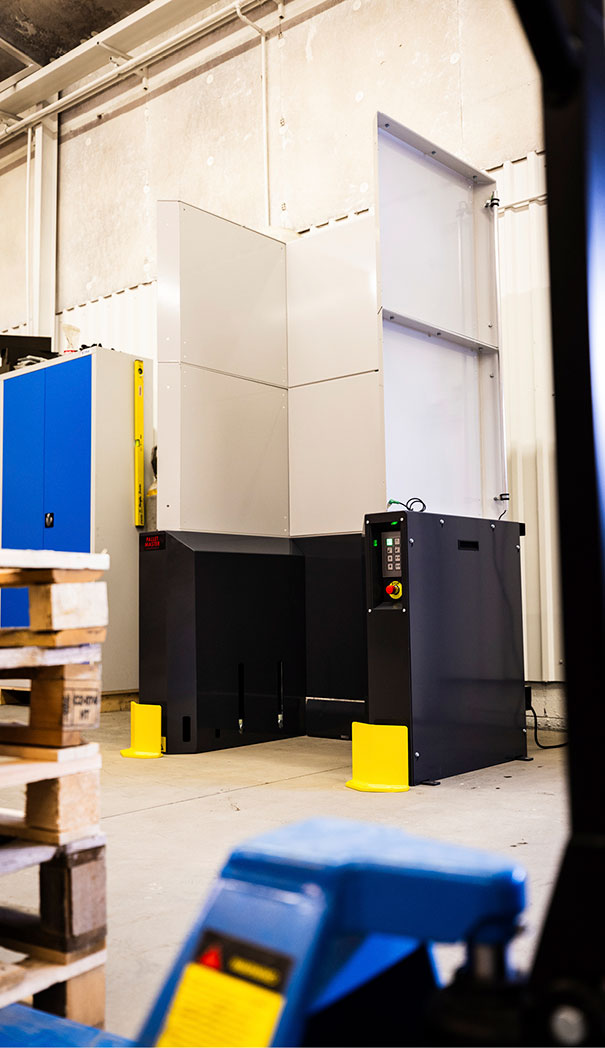 Empty gray M-size PalletMaster® pallet dispenser for half pallets.